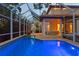 View of the home's pool and screened-in patio at dusk at 3307 W Knights Ave, Tampa, FL 33611
