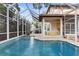 Spacious screened-in pool with connected covered patio and exterior seating at 3307 W Knights Ave, Tampa, FL 33611
