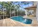 A screened-in pool and covered patio area provide ample outdoor living space at 3307 W Knights Ave, Tampa, FL 33611