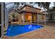 Covered patio and bright blue pool enclosed with a screened lanai at 3307 W Knights Ave, Tampa, FL 33611