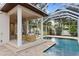 Exterior view of a screened-in pool and covered patio area at 3307 W Knights Ave, Tampa, FL 33611