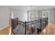 Staircase landing featuring wrought iron railing and natural light from an arched window at 3307 W Knights Ave, Tampa, FL 33611