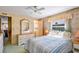 Charming bedroom with full bed, bedside tables, and large windows that let in natural light at 37812 Valencia Ave, Zephyrhills, FL 33541