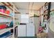 Laundry room with washer and dryer, shelving, storage cabinet, a window and various cleaning supplies at 37812 Valencia Ave, Zephyrhills, FL 33541