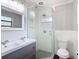 Bathroom showcases a glass enclosed shower, dual sink vanity, and tiled walls at 4002 Hudson Ter, Tampa, FL 33618