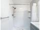 Bathroom with tile shower, white subway tile walls, and updated fixtures at 4002 Hudson Ter, Tampa, FL 33618