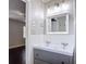 Bathroom featuring a dual sink vanity, white tile, and decorative lighting at 4002 Hudson Ter, Tampa, FL 33618