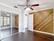 Bedroom featuring hardwood floors, a mirrored closet, and paneling detail at 4002 Hudson Ter, Tampa, FL 33618