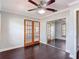 Bedroom featuring hardwood floors, french doors to the exterior, and a mirrored closet at 4002 Hudson Ter, Tampa, FL 33618