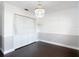 Bedroom showcases a decorative chandelier, closet with bifold doors, and neutral walls at 4002 Hudson Ter, Tampa, FL 33618