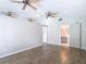 Large bedroom with wood-look tile flooring, ceiling fans, and access to a bathroom at 4002 Hudson Ter, Tampa, FL 33618