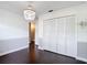 Bedroom features a closet with bifold doors, decorative chandelier, and neutral walls at 4002 Hudson Ter, Tampa, FL 33618