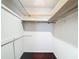 Walk-in closet with extensive shelving and hardwood floors at 4002 Hudson Ter, Tampa, FL 33618