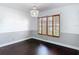 Dining room features hardwood floors, custom window shutters, and decorative lighting at 4002 Hudson Ter, Tampa, FL 33618