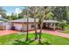 Home with a lush lawn, attached garage, and carport at 4002 Hudson Ter, Tampa, FL 33618