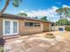 A house with a large outdoor patio with a built in fire pit at 4002 Hudson Ter, Tampa, FL 33618