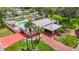A lush landscape surrounds this home that features a private pool, mature palms, and long driveway at 4002 Hudson Ter, Tampa, FL 33618