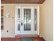 Elegant front door with decorative glass panels and a welcoming entrance mat at 4002 Hudson Ter, Tampa, FL 33618