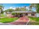 Charming single-story home with brick driveway, well-maintained lawn, and manicured landscaping at 4002 Hudson Ter, Tampa, FL 33618