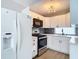 Modern kitchen features stainless steel appliances, white cabinetry, and stylish backsplash at 4002 Hudson Ter, Tampa, FL 33618
