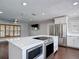 Kitchen island with stainless appliances, pendant lights and breakfast bar seating at 4002 Hudson Ter, Tampa, FL 33618