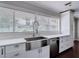 Bright kitchen with stainless steel appliances, white cabinets and countertops, and a large window view at 4002 Hudson Ter, Tampa, FL 33618