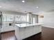 Bright kitchen with stainless steel appliances, white cabinets and countertops, and a large kitchen island at 4002 Hudson Ter, Tampa, FL 33618
