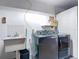 Functional laundry room featuring modern washer/dryer set and utility sink at 4002 Hudson Ter, Tampa, FL 33618