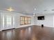 Bright living room with dark wood-look floors, ceiling fan and natural light at 4002 Hudson Ter, Tampa, FL 33618