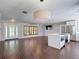 Bright living room open to the kitchen, with wood-look floors and recessed lights at 4002 Hudson Ter, Tampa, FL 33618