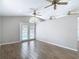 Living room with wood-look tile flooring and French doors leading to the pool area at 4002 Hudson Ter, Tampa, FL 33618
