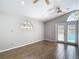 Living room with wood-look tile flooring, French doors leading to the outdoor area at 4002 Hudson Ter, Tampa, FL 33618