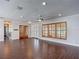 Spacious living room with window shutters, wood-look floors and recessed lighting at 4002 Hudson Ter, Tampa, FL 33618