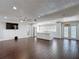 Spacious living room open to the kitchen with wood-look tile and recessed lighting at 4002 Hudson Ter, Tampa, FL 33618