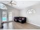 Bright living space featuring wood floors, a ceiling fan, and French doors at 4002 Hudson Ter, Tampa, FL 33618