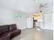 Open living space featuring a connecting kitchen with white cabinets and wood floors at 4002 Hudson Ter, Tampa, FL 33618