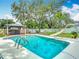 Backyard pool area with mature trees and lush landscaping at 4002 Hudson Ter, Tampa, FL 33618