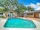 A beautiful backyard pool with a slide and outdoor fire pit at 4002 Hudson Ter, Tampa, FL 33618