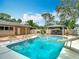 A gorgeous swimming pool with a slide and a bar area for outdoor entertaining at 4002 Hudson Ter, Tampa, FL 33618