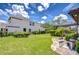 Spacious back yard with lush green grass, well-maintained landscaping, and a screened-in pool area at 4122 Natural Vista Ct, New Port Richey, FL 34655