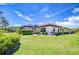 Beautiful backyard showcasing a well-manicured lawn, privacy landscaping, and a screened pool area at 4122 Natural Vista Ct, New Port Richey, FL 34655