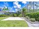Picturesque backyard with paver patio, garden beds, and lush greenery for outdoor enjoyment at 4122 Natural Vista Ct, New Port Richey, FL 34655