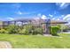 Green backyard with screen enclosed porch and meticulous landscaping, perfect for relaxation at 4122 Natural Vista Ct, New Port Richey, FL 34655