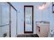 Bathroom with tiled walk-in shower and a single sink vanity with a door to the backyard at 4122 Natural Vista Ct, New Port Richey, FL 34655