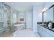 A luxurious bathroom featuring a glass enclosed shower, soaking tub, and double sink vanity at 4122 Natural Vista Ct, New Port Richey, FL 34655