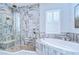Luxurious bathroom featuring a glass enclosed shower and soaking tub with decorative tile at 4122 Natural Vista Ct, New Port Richey, FL 34655