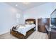Bright bedroom featuring shuttered windows, dark trim dresser, and light-colored wood-look floors at 4122 Natural Vista Ct, New Port Richey, FL 34655