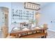 Dining room with rustic wooden table, bench seating, and elegant lighting at 4122 Natural Vista Ct, New Port Richey, FL 34655