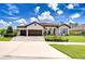 Beautiful single-story home featuring a three-car garage, paver driveway, and lush landscaping at 4122 Natural Vista Ct, New Port Richey, FL 34655