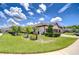 Beautiful front yard with lush lawn, mature landscaping, and a welcoming driveway leading to the garage at 4122 Natural Vista Ct, New Port Richey, FL 34655